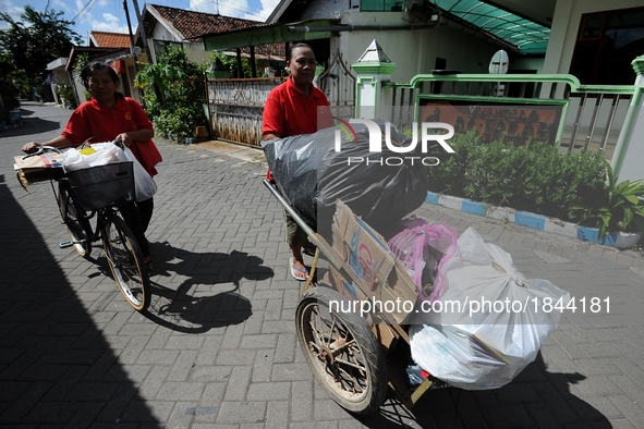 Two women push cart contain of garbage to Bank Sampah. 
Bank Sampah (Garbage Bank) is a small business unit in neighborhood community operat...