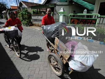 Two women push cart contain of garbage to Bank Sampah. 
Bank Sampah (Garbage Bank) is a small business unit in neighborhood community operat...