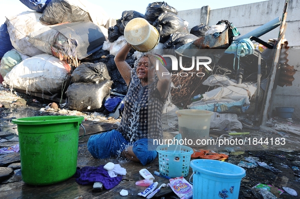 Nurtinah baths after work as a scavenger.
Nurtinah, 47, a farm worker from Pucang Anom village, Cerme sub-district, Bondowoso district, East...