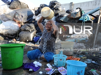 Nurtinah baths after work as a scavenger.
Nurtinah, 47, a farm worker from Pucang Anom village, Cerme sub-district, Bondowoso district, East...