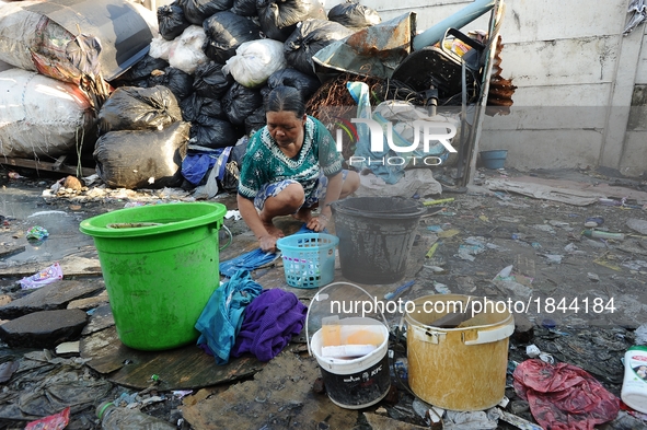 Nurtinah washes her clothes after work as a scavenger.
Nurtinah, 47, a farm worker from Pucang Anom village, Cerme sub-district, Bondowoso d...