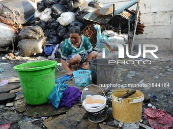 Nurtinah washes her clothes after work as a scavenger.
Nurtinah, 47, a farm worker from Pucang Anom village, Cerme sub-district, Bondowoso d...