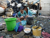 Nurtinah washes her clothes after work as a scavenger.
Nurtinah, 47, a farm worker from Pucang Anom village, Cerme sub-district, Bondowoso d...