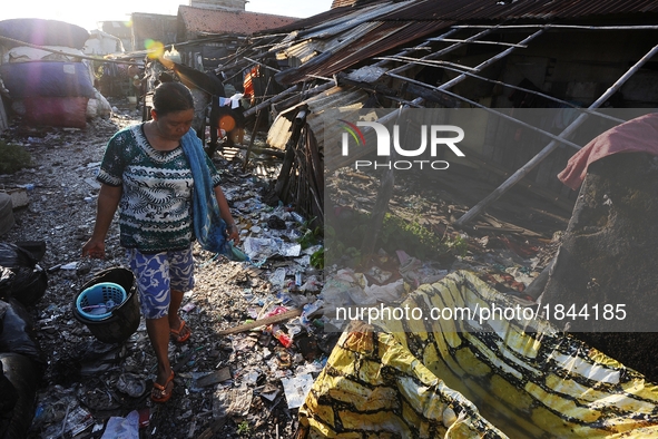 Nurtinah walks for bathing after work as a scavenger.
Nurtinah, 47, a farm worker from Pucang Anom village, Cerme sub-district, Bondowoso di...