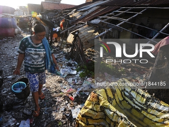 Nurtinah walks for bathing after work as a scavenger.
Nurtinah, 47, a farm worker from Pucang Anom village, Cerme sub-district, Bondowoso di...