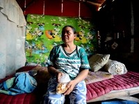 Nurtinah takes a break after working as a scavenger in her small hut.
Nurtinah, 47, a farm worker from Pucang Anom village, Cerme sub-distri...