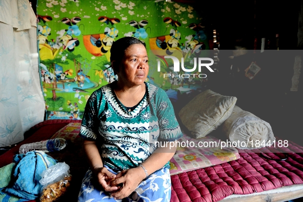 Nurtinah takes a break after working as a scavenger in her small hut.
Nurtinah, 47, a farm worker from Pucang Anom village, Cerme sub-distri...