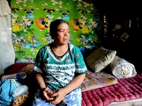 Nurtinah takes a break after working as a scavenger in her small hut.
Nurtinah, 47, a farm worker from Pucang Anom village, Cerme sub-distri...