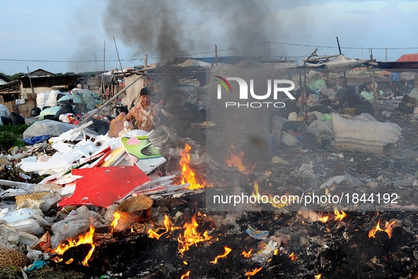 Nurtinah burns styrofoam and others materials that cannot be recycled.
Nurtinah, 47, a farm worker from Pucang Anom village, Cerme sub-distr...