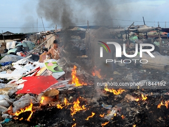 Nurtinah burns styrofoam and others materials that cannot be recycled.
Nurtinah, 47, a farm worker from Pucang Anom village, Cerme sub-distr...