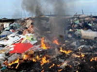 Nurtinah burns styrofoam and others materials that cannot be recycled.
Nurtinah, 47, a farm worker from Pucang Anom village, Cerme sub-distr...