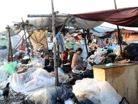 Nurtinah sorts the garbage.
Nurtinah, 47, a farm worker from Pucang Anom village, Cerme sub-district, Bondowoso district, East Java Province...