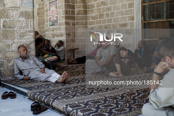 Palestinian in front of the Great Mosque of Gaza in Gaza City before Friday prayers on July 18th, 2014.