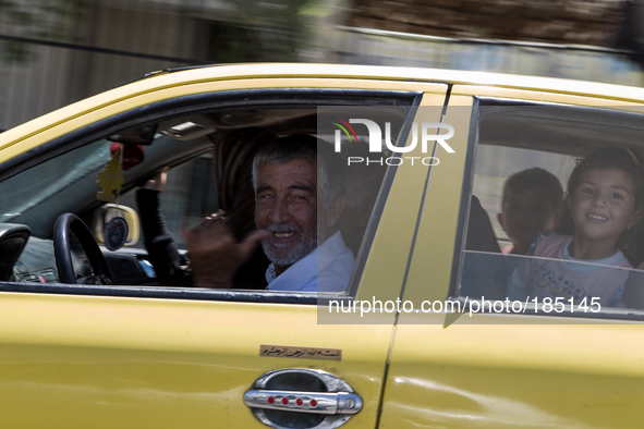 A Palestinian family driving to one of the many make-shift refugee shelters in Gaza on July 18th, 2014.