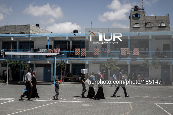 A family arriving at a make-shift refugee camp in Jabalya, Gaza on July 18th, 2014. The former school currently holds approximately 3500 Pal...