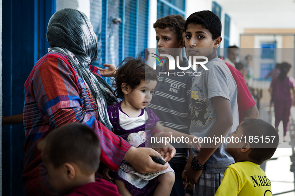 A family at a make-shift refugee camp in Jabalya, Gaza on July 18th, 2014. The former school currently holds approximately 3500 Palestinian....