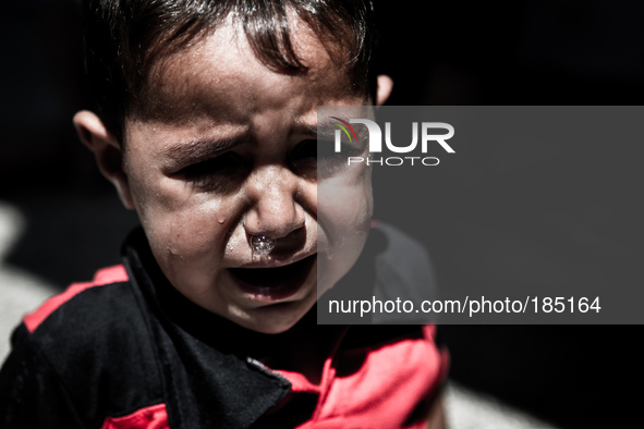 A young boy crying in a make-shift refugee camp in Jabalya, Gaza on July 18th, 2014. The former school currently holds approximately 3500 Pa...