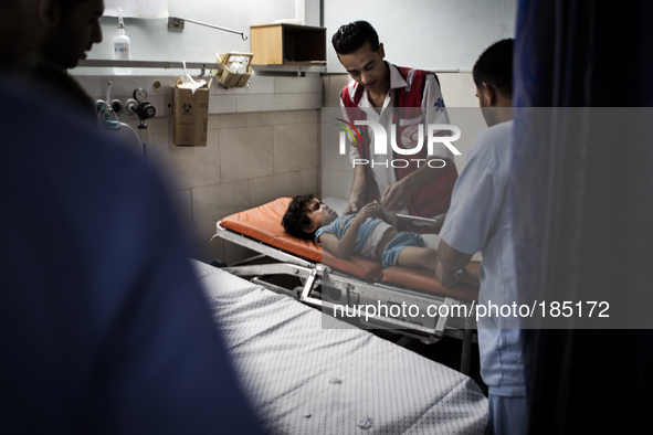 A young boy with a broken leg arrives in Shifa Hospital in Gaza City minutes after his home was attacked with missiles on July 19th, 2014.