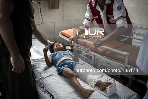 A young boy with a broken leg arrives in Shifa Hospital in Gaza City minutes after his home was attacked with missiles on July 19th, 2014.