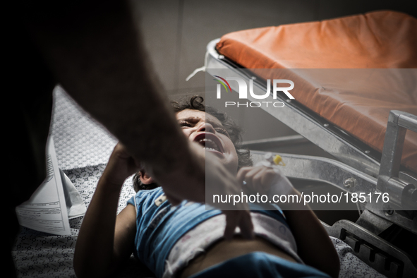 A young boy with a broken leg arrives in Shifa Hospital in Gaza City minutes after his home was attacked with missiles on July 19th, 2014.