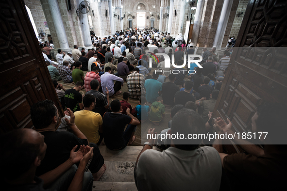 Men praying inside the Great Mosque of Gaza in Gaza City on July 18th, 2014.