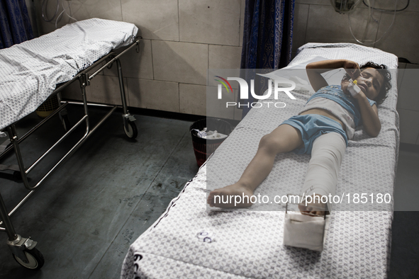 A young boy with a broken leg arrives in Shifa Hospital in Gaza City minutes after his home was attacked with missiles on July 19th, 2014.