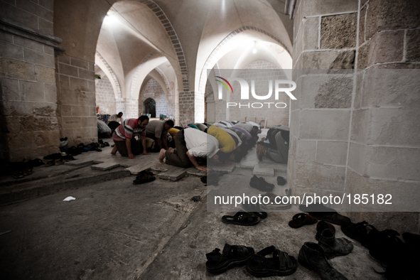 Men praying inside the Great Mosque of Gaza in Gaza City on July 18th, 2014.