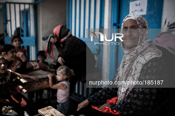 A woman insider a make-shift refugee camp in Jabalya, Gaza on July 18th, 2014. The former school currently holds approximately 3500 Palestin...