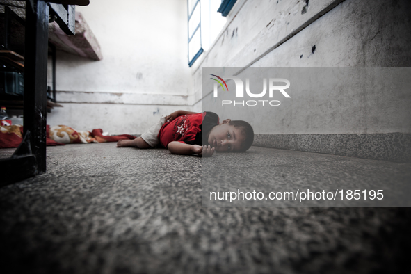 A child sleeping on the floor of a make-shift refugee camp in Jabalya, Gaza on July 18th, 2014. The former school currently holds approximat...