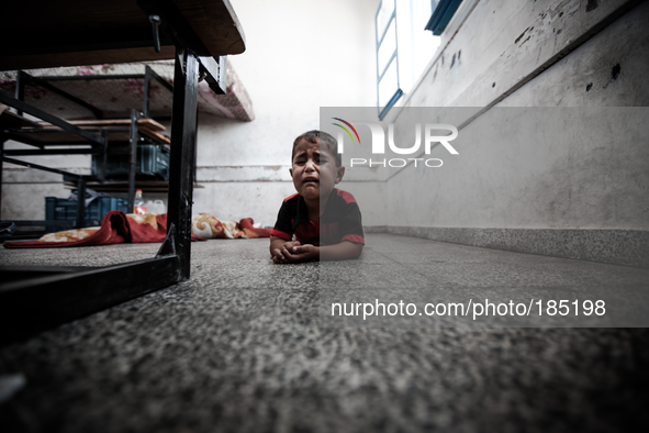 A child sleeping on the floor of a make-shift refugee camp in Jabalya, Gaza on July 18th, 2014. The former school currently holds approximat...