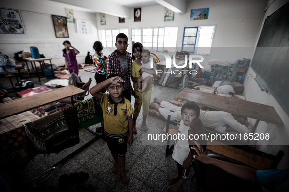 Families in a make-shift refugee camp in Jabalya, Gaza on July 18th, 2014. The former school currently holds approximately 3500 Palestinian....