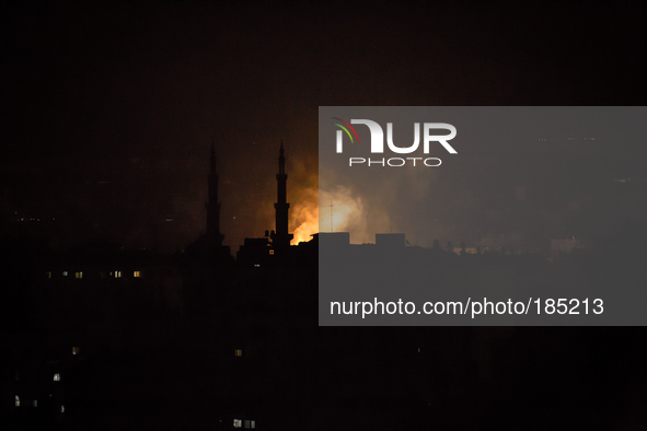 A fire seen next to a Mosque in the district of Jabalia in the east of Gaza City on the second night of the Israeli ground invasion in July...