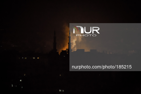 A fire seen next to a Mosque in the district of Jabalia in the east of Gaza City on the second night of the Israeli ground invasion in July...