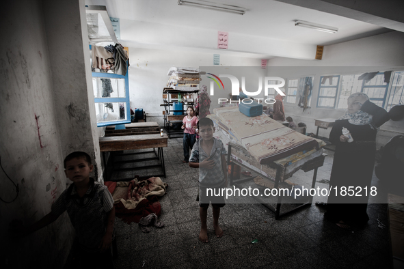 A Palestine family in a make-shift refugee camp in Jabalya, Gaza on July 18th, 2014. The former school currently holds approximately 3500 Pa...