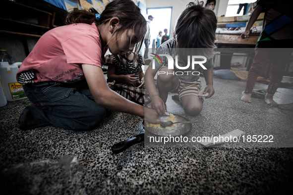 Children eating in a make-shift refugee camp in Jabalya, Gaza on July 18th, 2014. The former school currently holds approximately 3500 Pales...