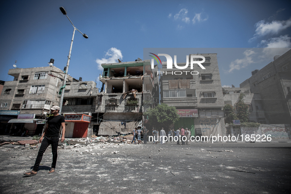 People gather in front of a civilian house on Jaffa Street in Northern Gaza City on July 20th, 2014 minutes after it has been attacked by an...