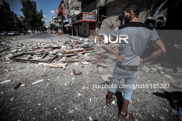 A man standing in front of his house on Jaffa Street in Northern Gaza City on July 20th, 2014 minutes after it has been attacked by an Israe...