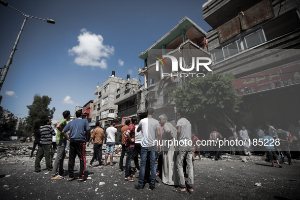 People gather in front of a civilian house on Jaffa Street in Northern Gaza City on July 20th, 2014 minutes after it has been attacked by an...