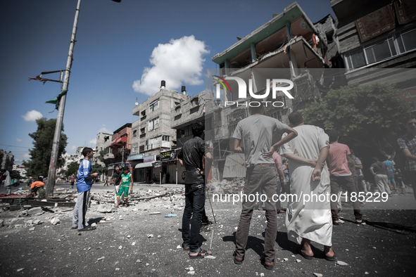 People gather in front of a civilian house on Jaffa Street in Northern Gaza City on July 20th, 2014 minutes after it has been attacked by an...