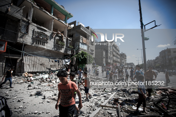 People gather in front of a civilian house on Jaffa Street in Northern Gaza City on July 20th, 2014 minutes after it has been attacked by an...