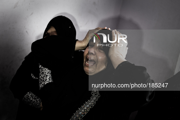 A woman mourns about the death of two brothers (5 and 9 years) that have been killed by an Israeli tank shell in Gaza City on July 20th, 201...