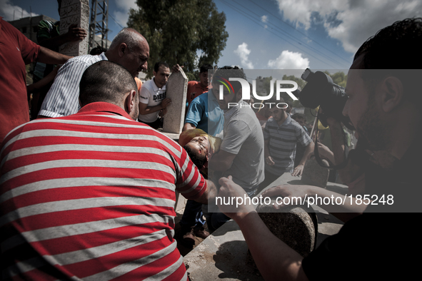 The dead body of a young boy (9 years) who was killed by a tank shell in Gaza City is being burried on a graveyard in Gaza City on July 20th...