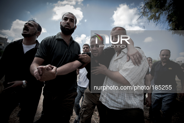 The father of two children (5 and 9 years) that have been killed by a tank shell on July 20th, 2014 in Gaza City collapsed during their fune...