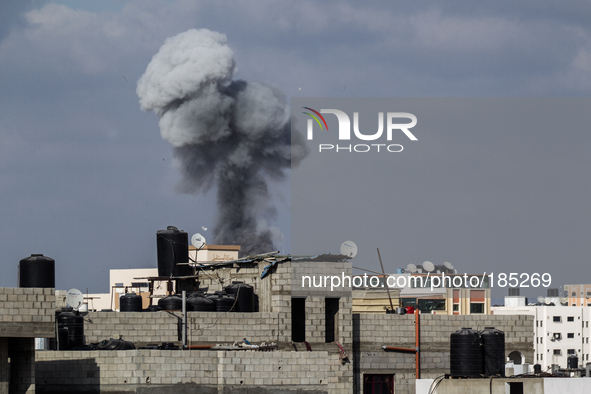 Dark smoke can be seen over the eastern district of Gaza City after a F-16 missile strikes a building on July 19th, 2014.