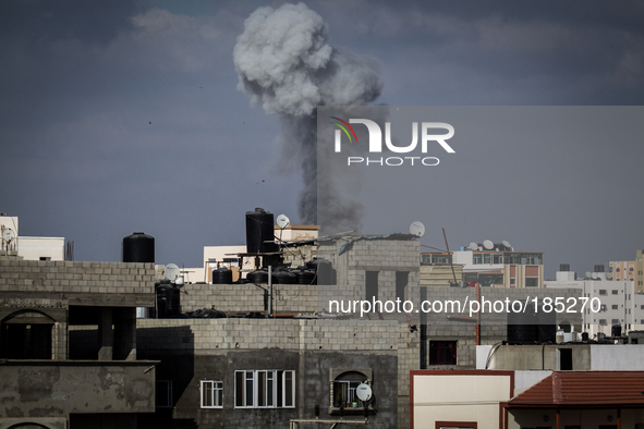 Dark smoke can be seen over the eastern district of Gaza City after a F-16 missile strikes a building on July 19th, 2014.