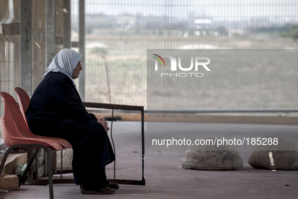 A Palestinian woman sitting at the Israeli border crossing at Erez on July 20th, 2014 to escape the war in Gaza.