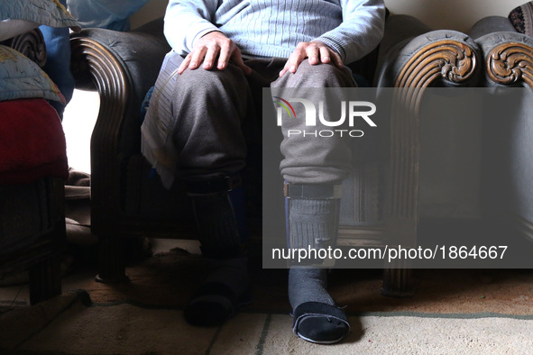 Syrian Abu Mohammed, who was injured by an air strike, uses a walker at his home in the rebel-held town of Douma, on the outskirts of the ca...