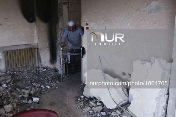 Syrian Abu Mohammed, who was injured by an air strike, uses a walker at his home in the rebel-held town of Douma, on the outskirts of the ca...