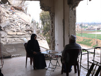 Syrian Umm Mohammed, and her husband drink coffee at their destroyed home in the rebel-held town of Douma, on the outskirts of the capital D...