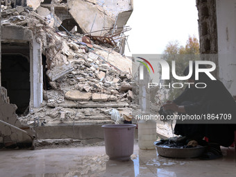 Syrian Umm Mohammed, washes laundry at her home in the rebel-held town of Douma, on the outskirts of the capital Damascus, on March 25, 2017...